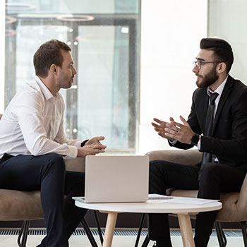 Two men engaged in sales coaching